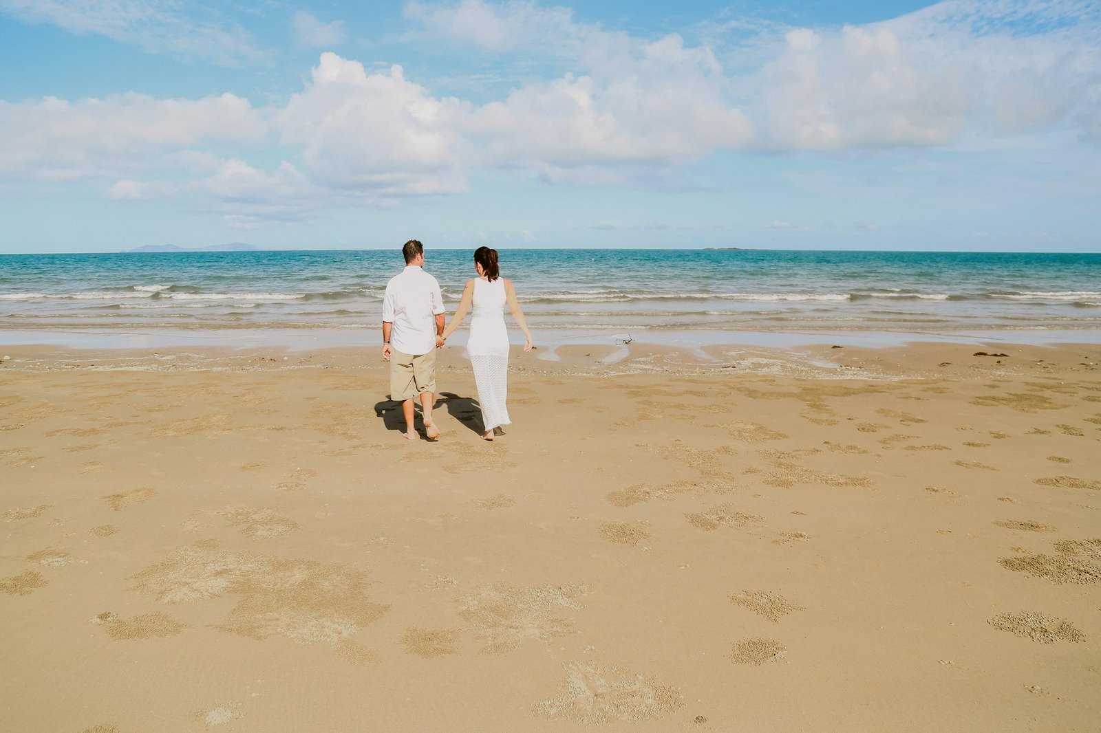 Back view of a couple on the beach