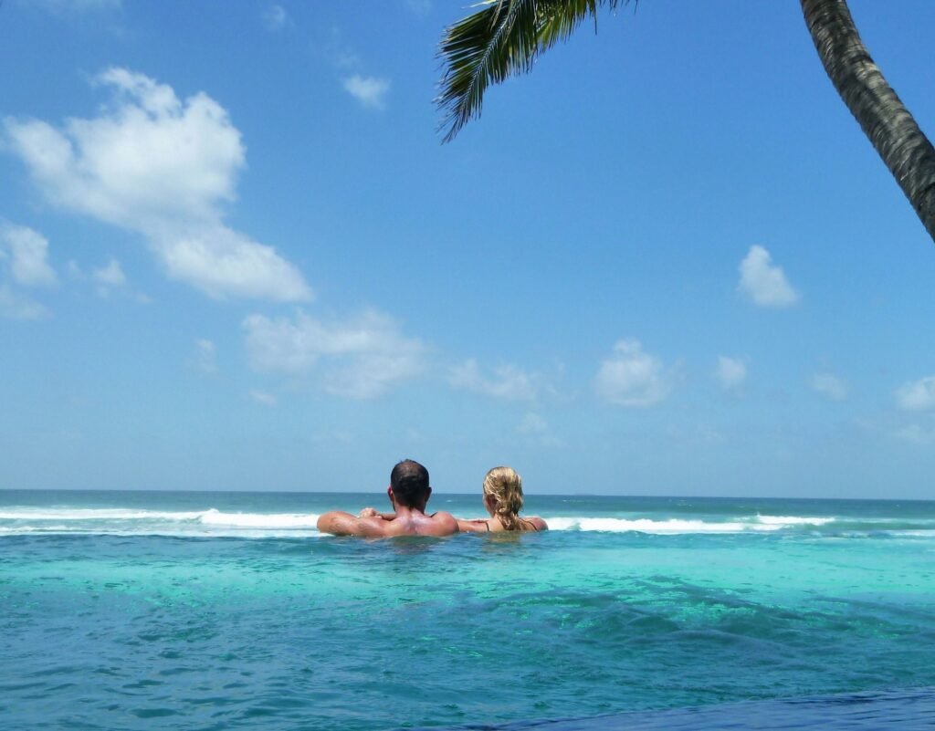 Couple in the infinity pool at a tropical vacation destination